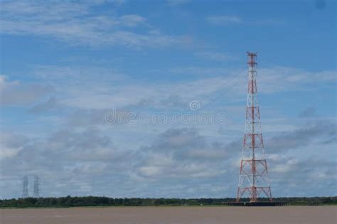 A Row Of Red And White Electricity Transmission Towers Over The Amazon