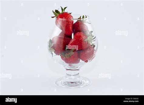 Strawberrys in a cup isolated on white background Stock Photo - Alamy