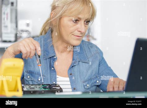 Mature Woman Trying To Fix A Computer Stock Photo Alamy