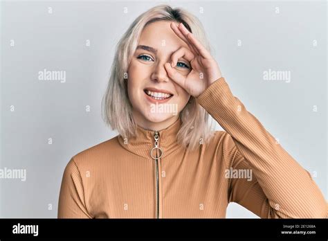 Young Blonde Girl Wearing Casual Clothes Doing Ok Gesture With Hand