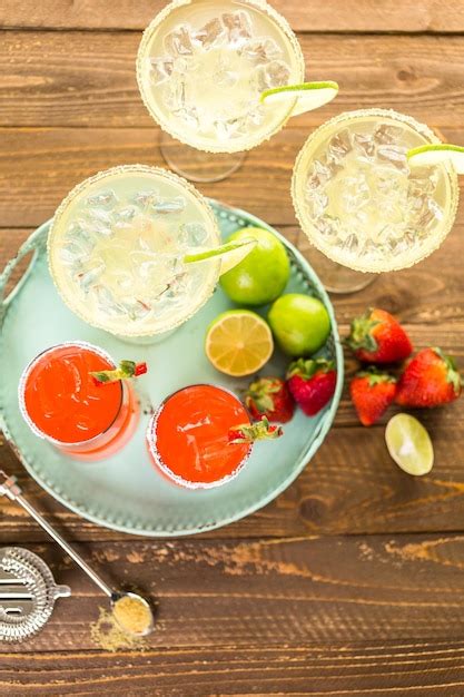 Premium Photo Classic Lime And Strawberry Margaritas On The Rocks