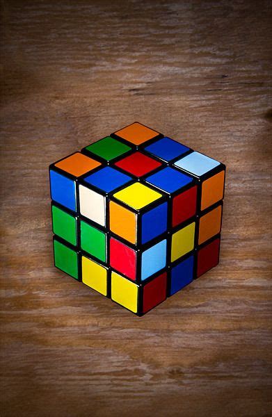 A Rubik Cube Sitting On Top Of A Wooden Table