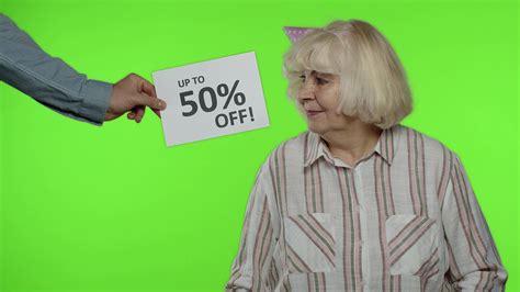 Advertisement Up To 50 Percent Off Appears Next To Grandmother Woman Dancing With Shopping Bags