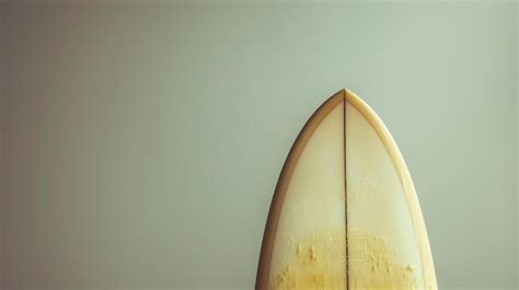 Premium Photo A Surfboard Leaning Against A Wall With A Light Blue