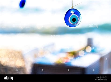 The evil eye bead in the beach Stock Photo - Alamy