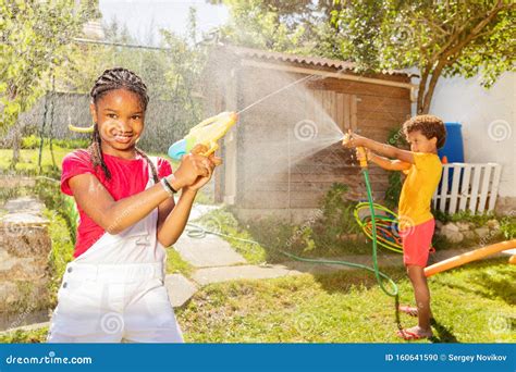 Kids Play with Water Hold Gun and Garden Sprinkler Stock Photo - Image ...