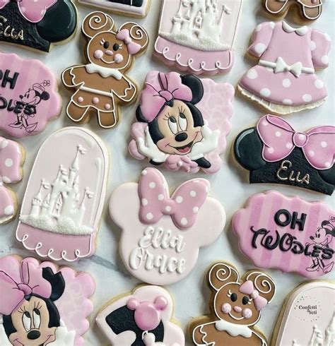 Many Decorated Cookies Are Arranged On A Table With Pink And White