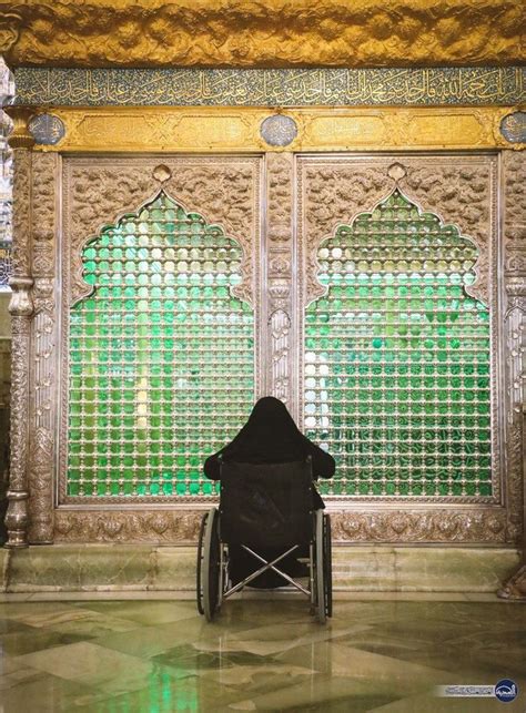 A Person Sitting In A Chair Next To A Wall With Green And Gold Glass