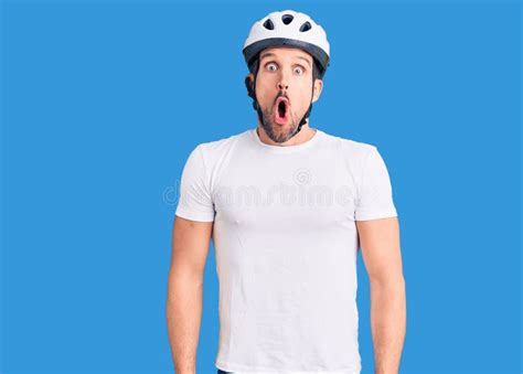 Young Handsome Man Wearing Bike Helmet Afraid And Shocked With Surprise