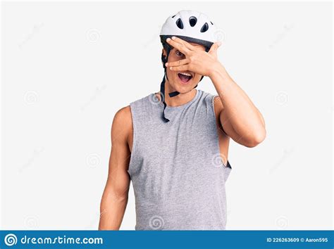 Young Handsome Man Wearing Bike Helmet Peeking In Shock Covering Face