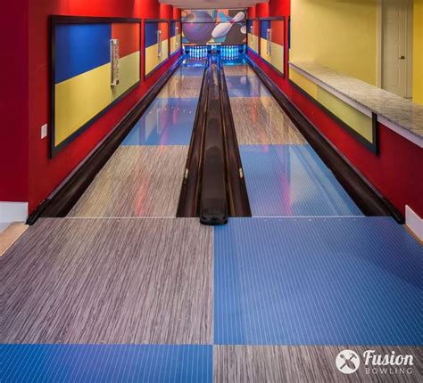 An Empty Bowling Alley With Colorful Walls And Flooring