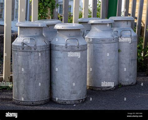 Old Fashioned Milk Churns By Fence Vintage Agriculture Stock Photo Alamy