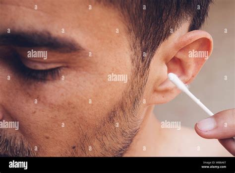 Man About To Clean His Ears Using Q Tip Cotton Swab Hygiene Essentials