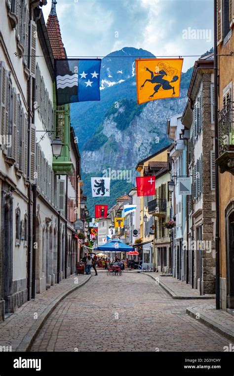 Typcial historic facade with flags in the centre of Saint-Maurice ...