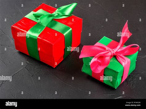 Red and green box with gifts on concrete background Stock Photo - Alamy