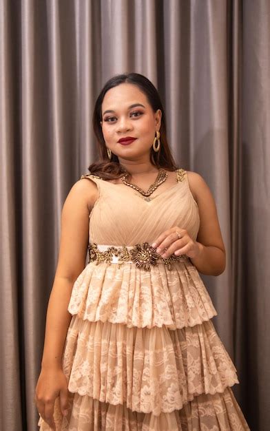 Premium Photo An Asian Woman Wearing A Brown Dress While Attending A