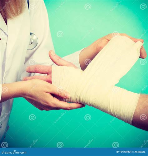 Doctor Bandaging Sprained Wrist. Stock Photo - Image of visit, accident