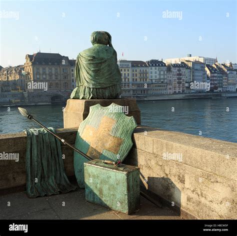 A photograph of the Helvetia statue on the Rhine river in Basel, Switzerland, taken on a sunny ...