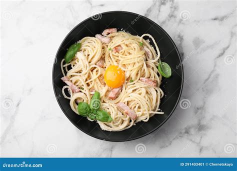 Delicious Pasta Carbonara With Egg Yolk On White Marble Table Top View