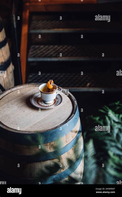 Hot Toddy With Orange In Teacup On Whiskey Barrel Stock Photo Alamy