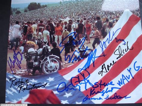 An Autographed Photo Of People Gathered Around A Motorcycle With The