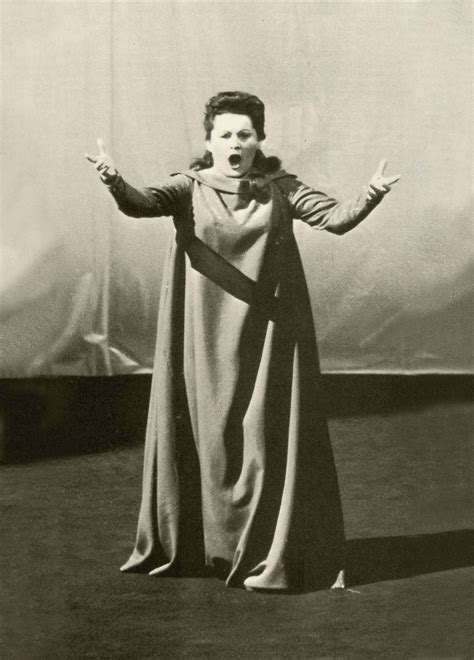 An Old Black And White Photo Of A Woman Wearing A Long Dress With Her