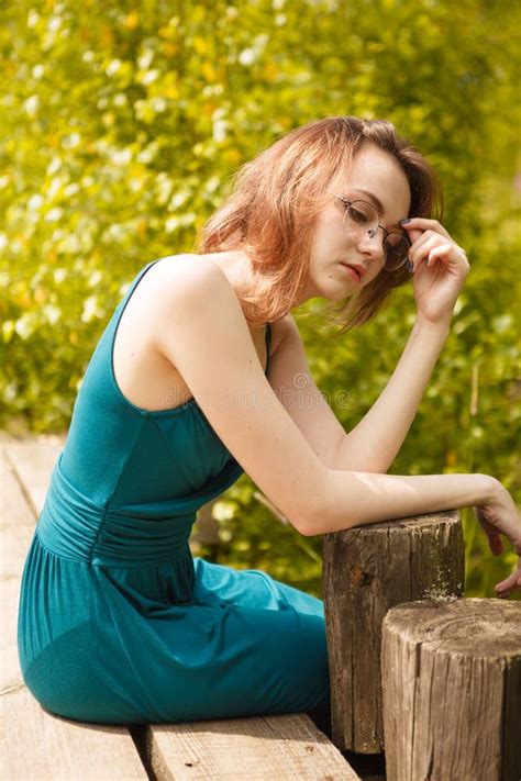 Young Girl In Blue Dress Sitting On Wooden Pier Stock Image Image Of