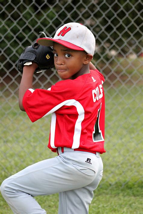 Royalty-Free photo: Baseball player kid wearing red and white jersey ...