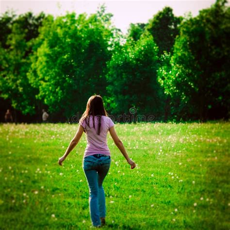 Back View Of Girl Walking At Green Field Outdoor Summer Portrait Of