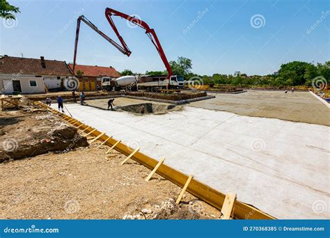 Mixer Truck On The Site Worker Holds Pump To Pours Concrete Into