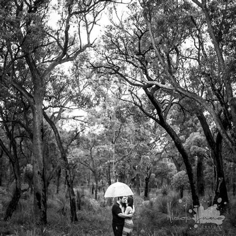 Black And White Photograph Of Two People Under An Umbrella In The Woods