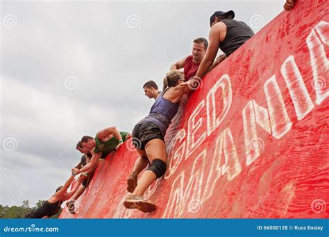 Competitors Struggle To Climb Wall In Extreme Obstacle Course Race