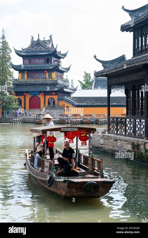 Tourist sightseeing boat cruising pass Yuanjin Temple in Zhujiajiao Ancient Water Town, a ...