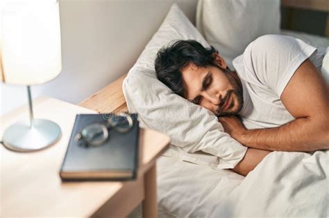 Young Hispanic Man Lying On Bed Sleeping At Bedroom Stock Image Image