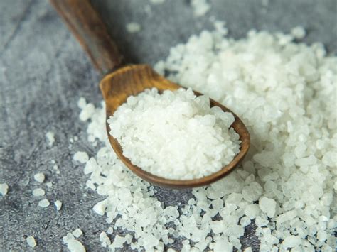 Premium Photo Sea Salt A Pile Of Sea Salt In A Wooden Spoon On A Dark