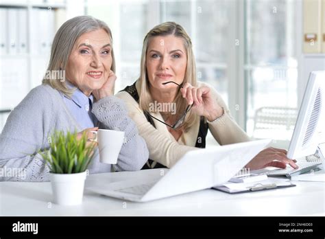 Two Excited Mature Women Working In Office Stock Photo Alamy