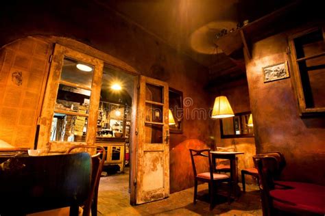 Interior Design Of Cozy Old Cafe With Wooden Furniture, Doors And Lamps ...