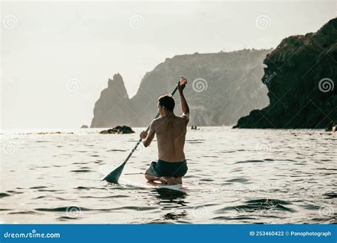 Side View Foto Of A Man Swiming And Relaxing On The Sup Board Sportive