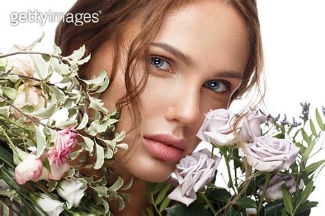 Beautiful Woman With Classic Nude Make Up Light Hairstyle And Flowers