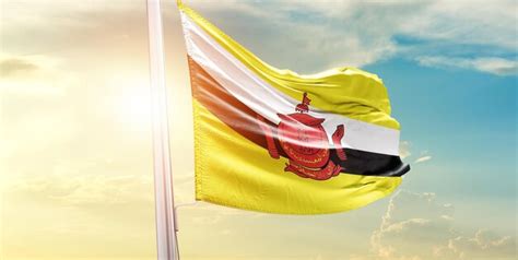 Premium Photo Brunei National Flag Waving In Beautiful Sky