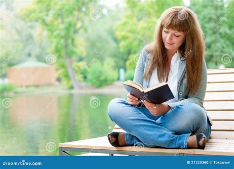 Girl Sitting Alone On Bench Reading