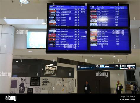 An arrivals screen at Sydney International Airport Stock Photo - Alamy