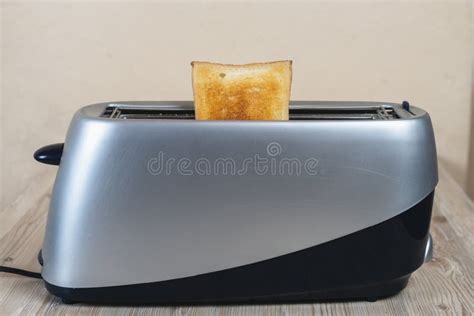 Toasted Bread In Toaster On A Wooden Table With Copy Space Stock Image