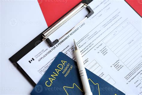 Application For Permanent Resident Card On Table With Pen And Canadian