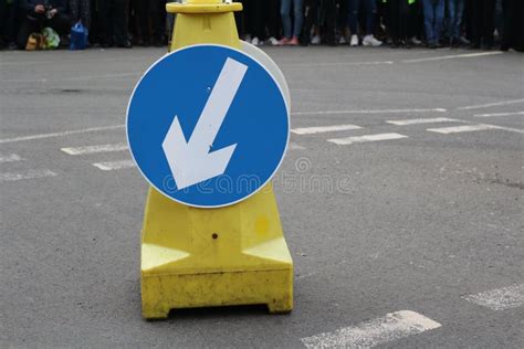 White Arrow on Blue Traffic Sign on Road Stock Image - Image of people ...