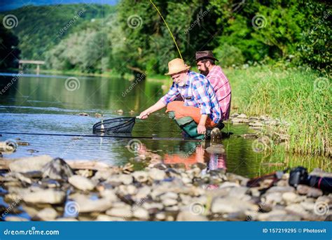 Rural Getaway Retired Dad And Mature Bearded Son Two Male Friends Fishing Together Stock Image