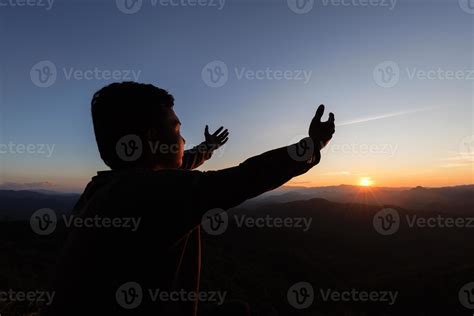 Silhouette Of A Man Praying Hands With Faith In Religion And Belief In