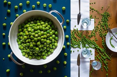 Premium Photo Green Peas In Bowl And On A Table Blue Background