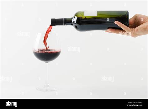 Hand Pouring Glass Of Wine