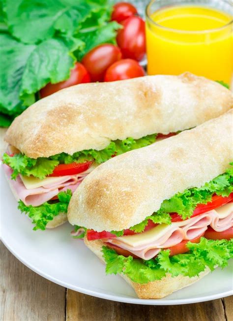 Ciabatta Bread Sandwiches With Ham And Cheese On The White Plate Stock